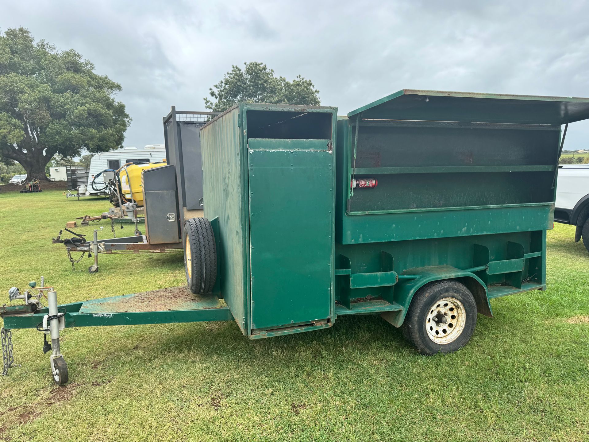 Green Trailer with Side Door and Roof Hatch, Parked on Grass — Bundaberg Auction Centre in Gooburrum, QLD