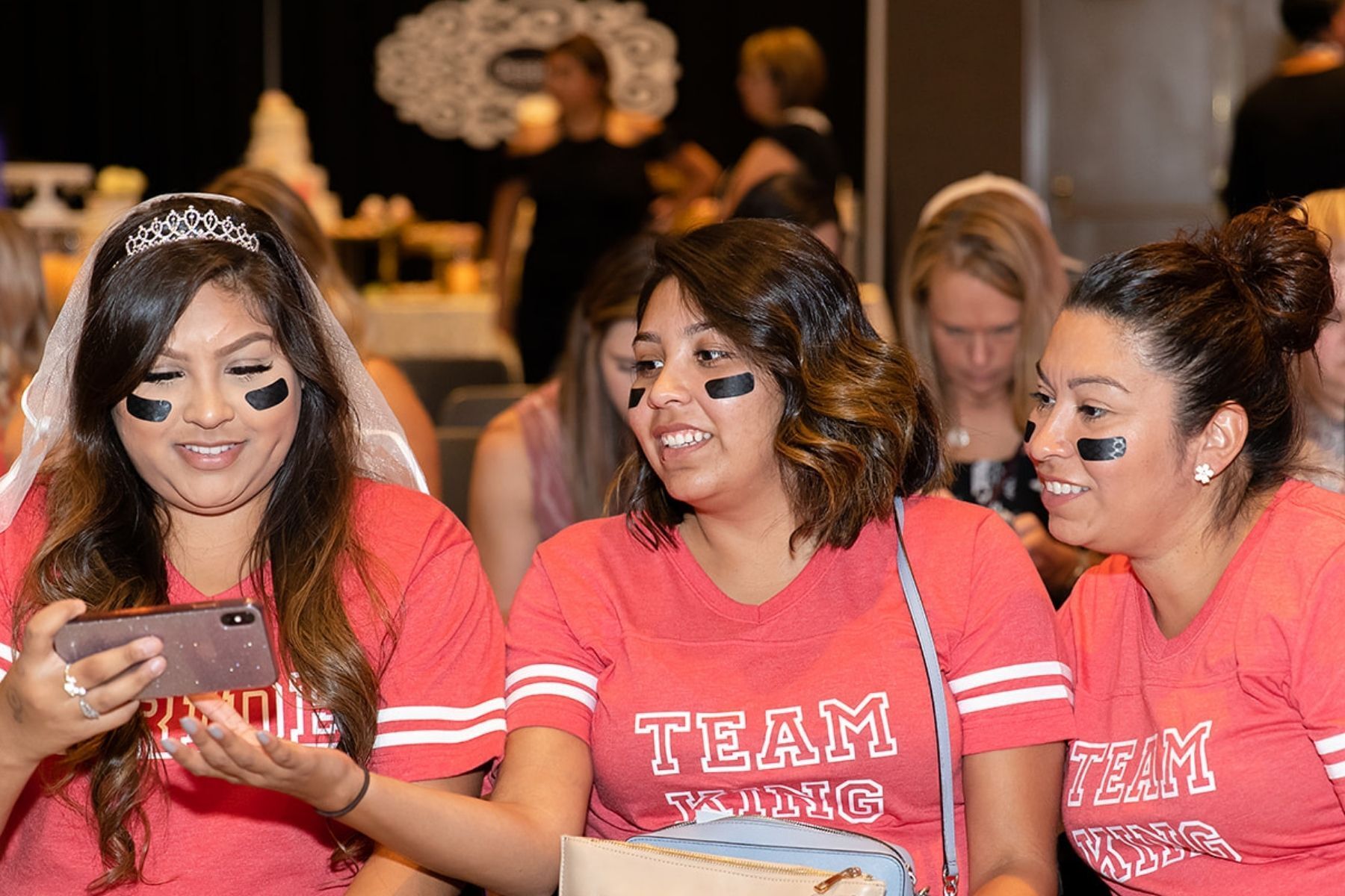 bride and three bridesmaids dressed in football jerseys, team bride to win prizes at modesto bridal fair
