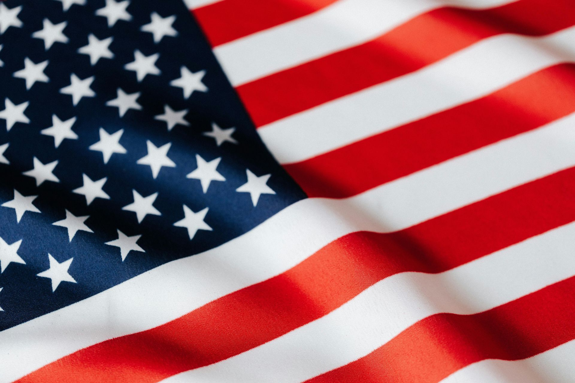 A close up of an american flag waving in the wind