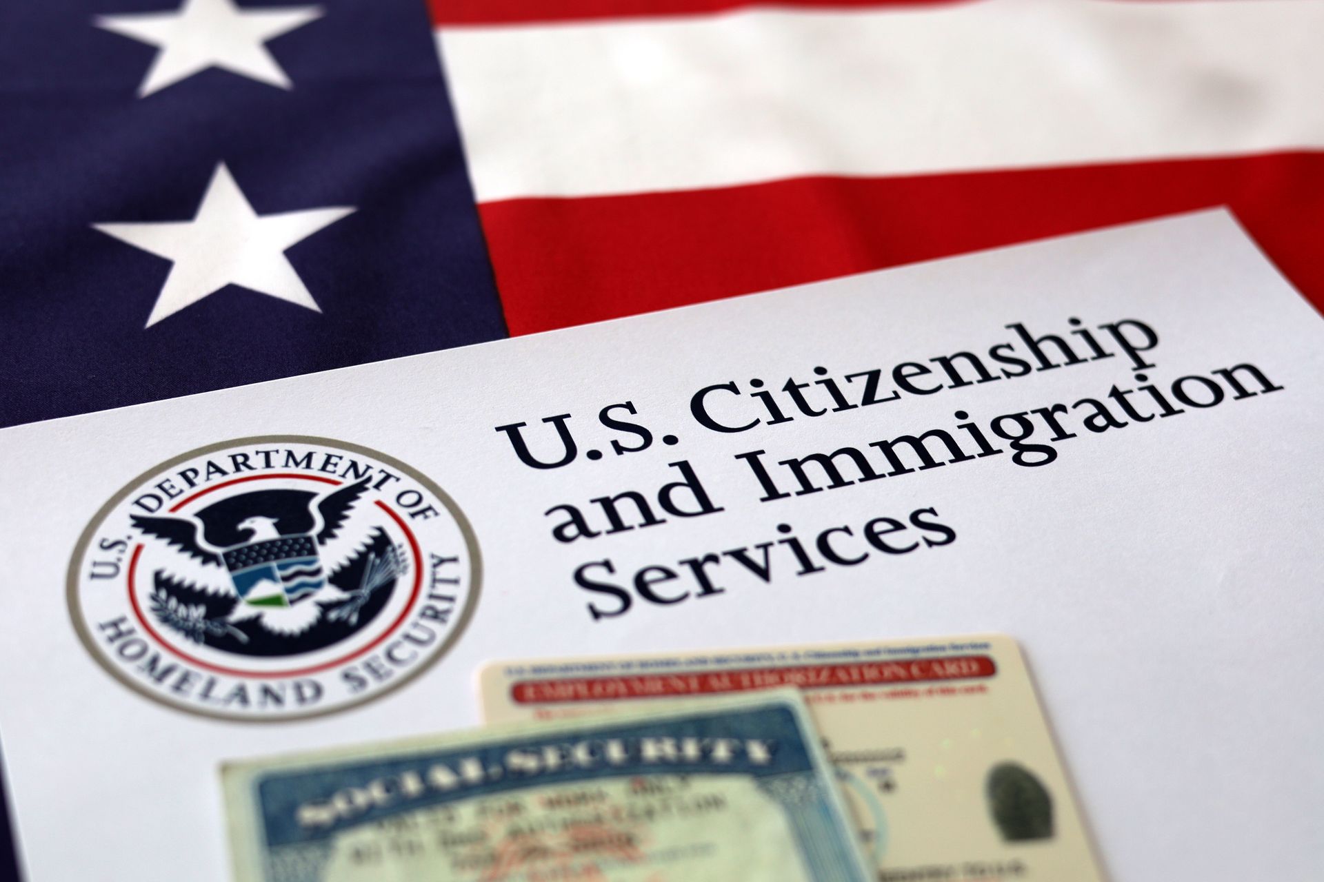 A u.s. citizenship and immigration services document with an american flag in the background