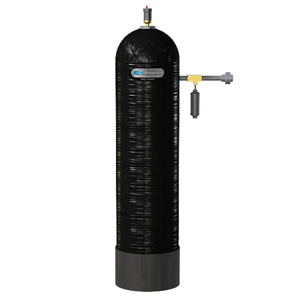 Tall black water filtration system with attached pipes and a gauge, for residential use.