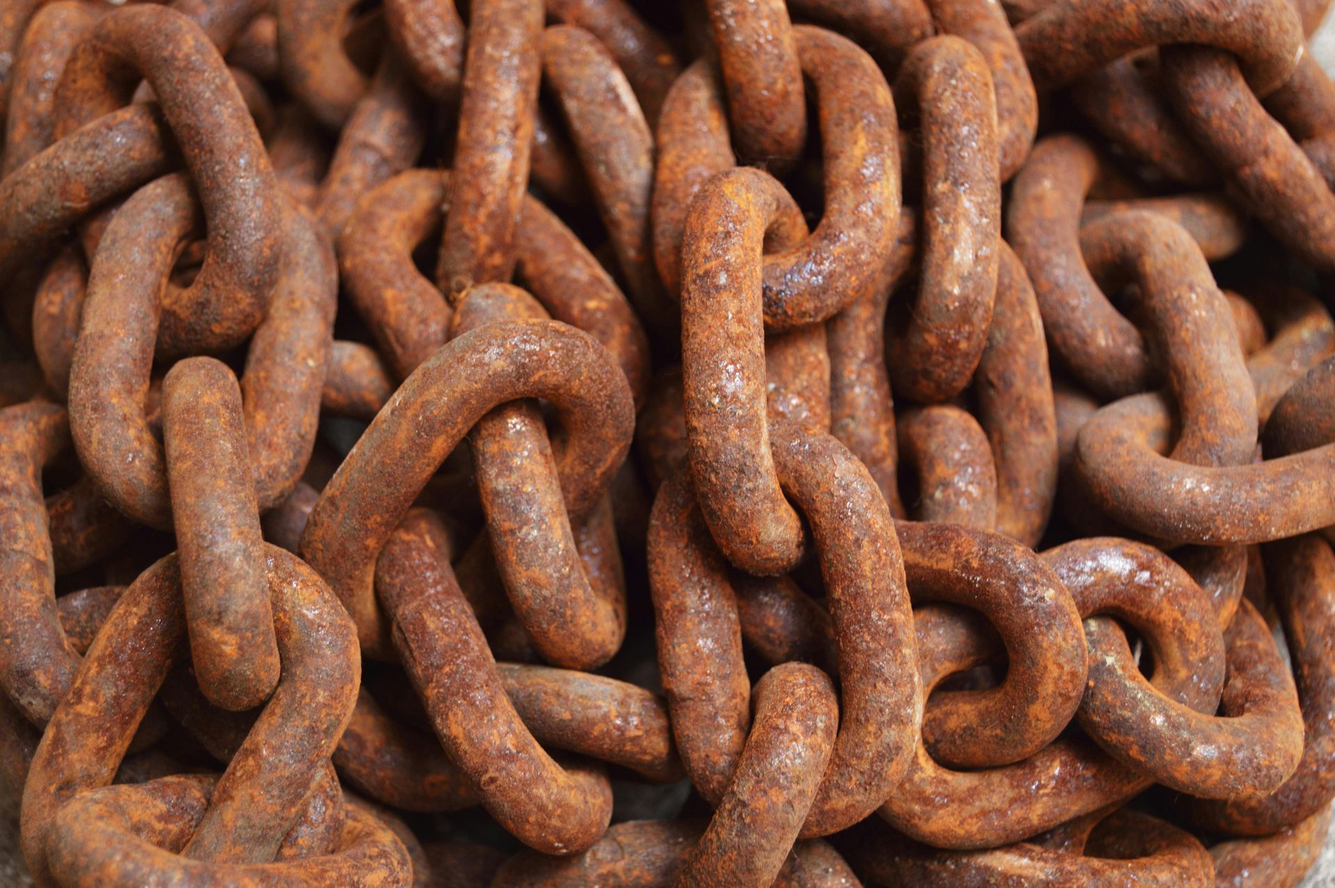 Rusty metal chain links intertwined, close-up.