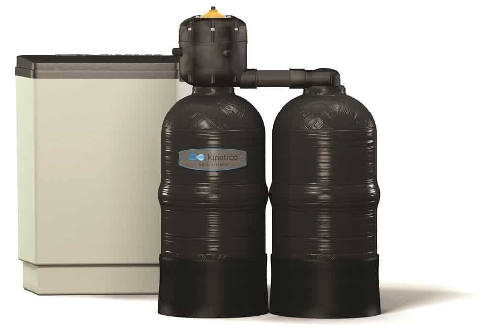 A water softener system: two black tanks with a beige salt tank.