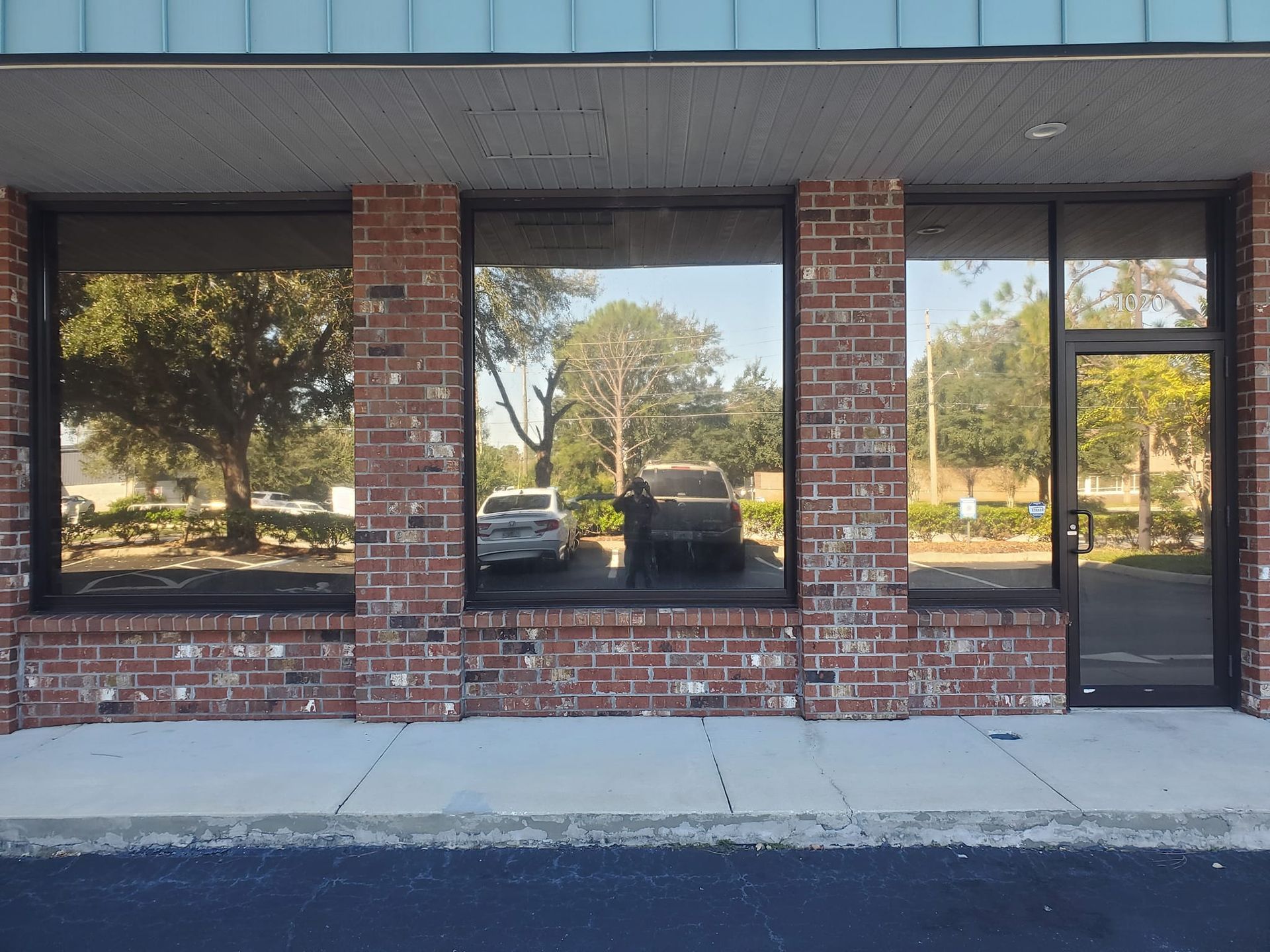 A brick building with cars parked in front of it
