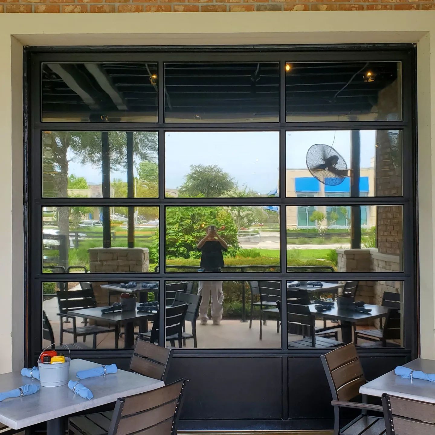 A restaurant with tables and chairs and a large window