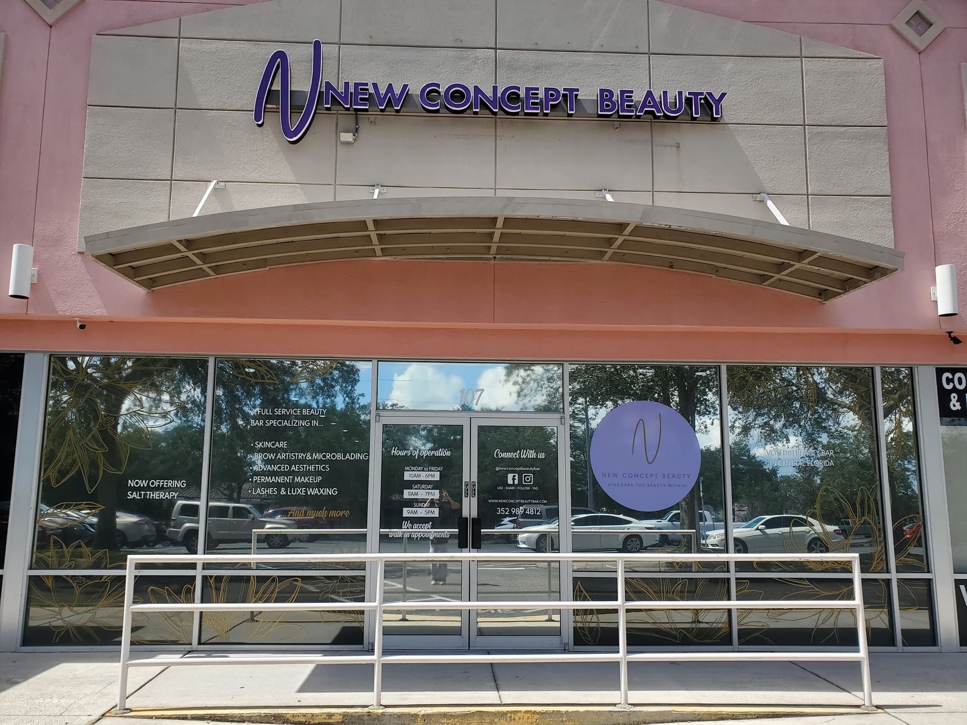 A pink building with a sign that says anew concept beauty