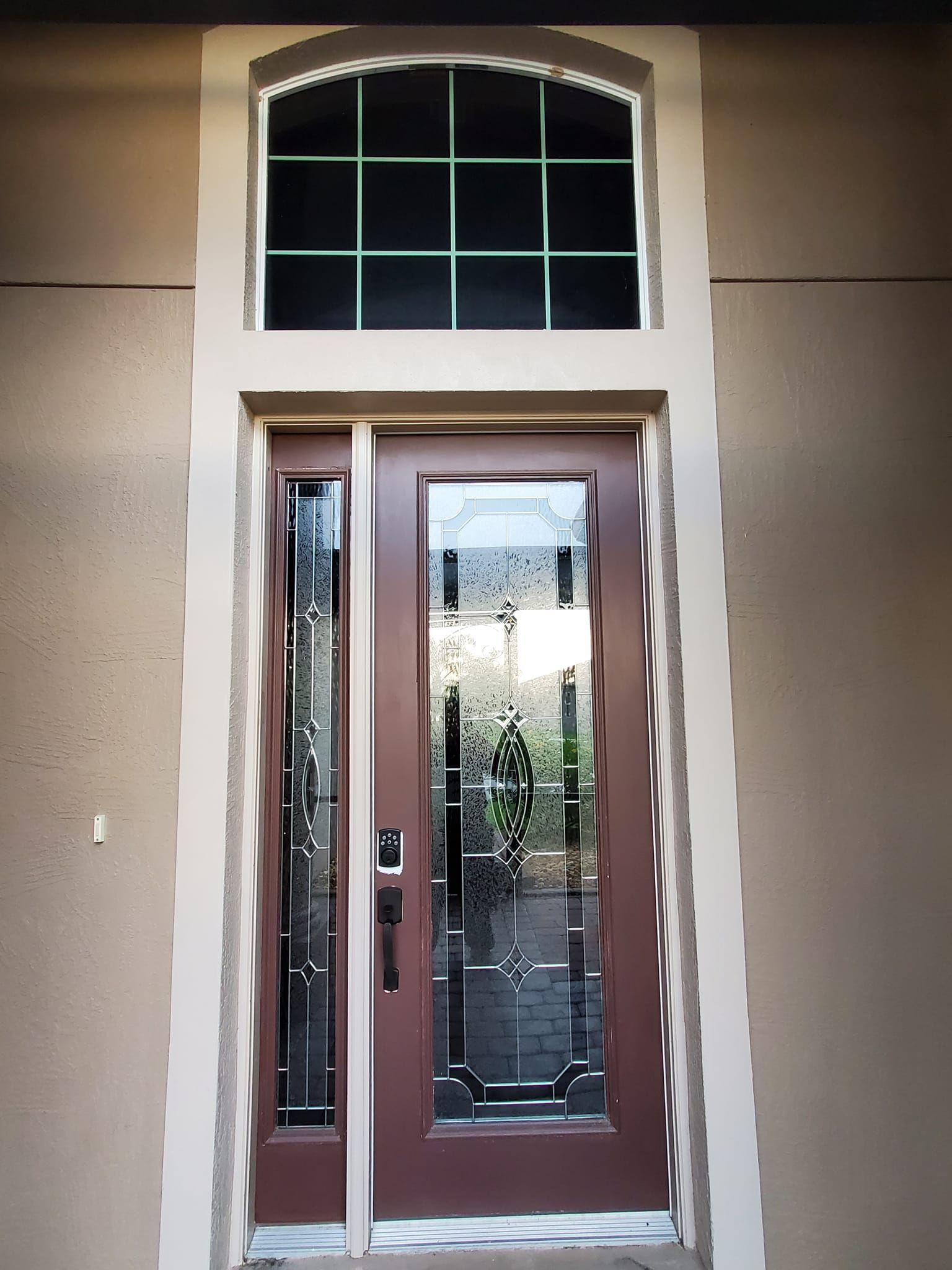 A brown door with a window above it