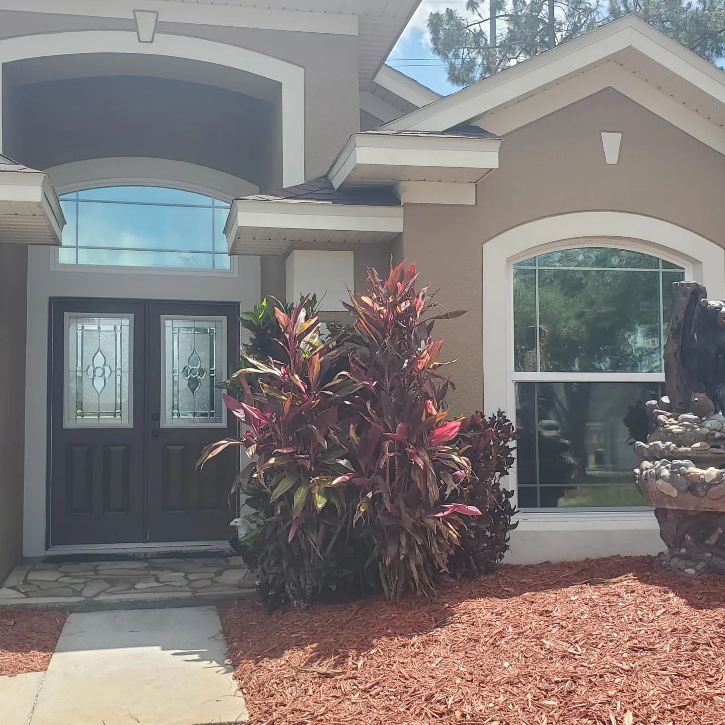 A house with a fountain in front of it