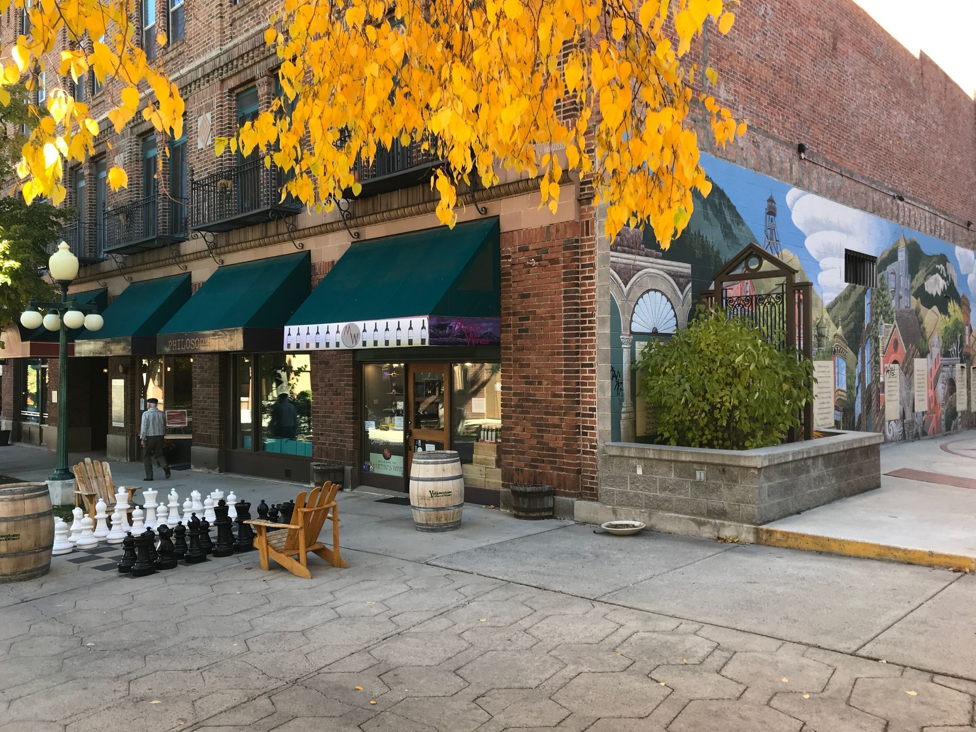 A store front with a mural on the side of it