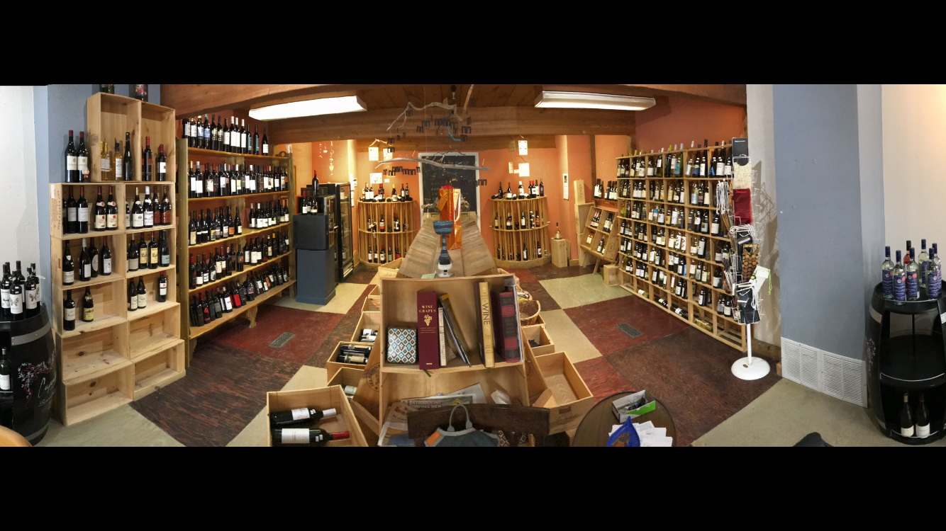A large room filled with lots of wine bottles on shelves.