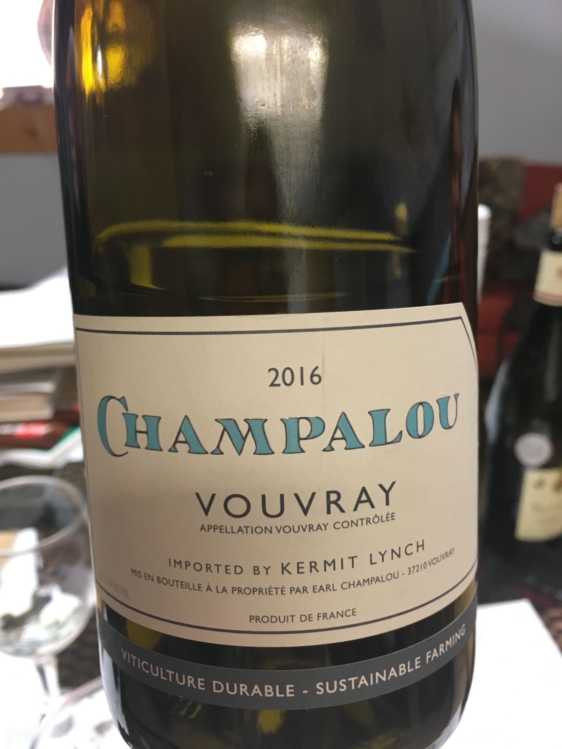A bottle of champalou wine is sitting on a table.