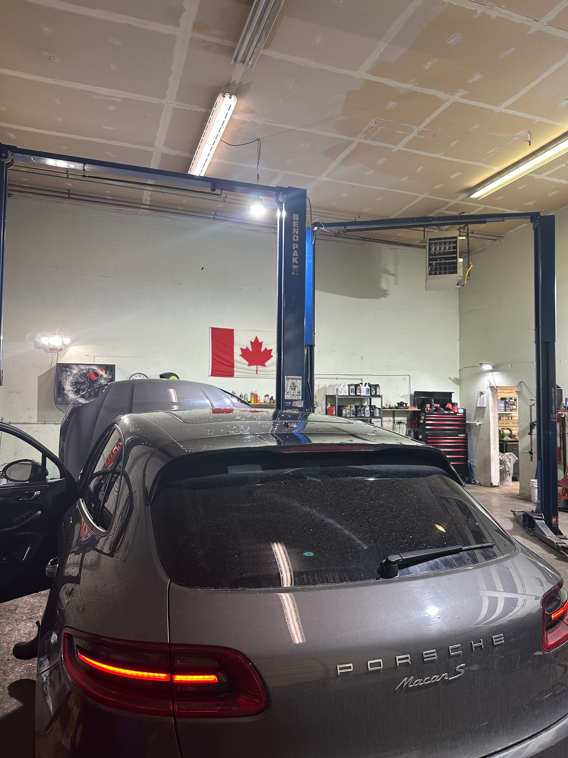 A silver Porsche SUV in a car repair shop | Precision Axle Repair Ltd