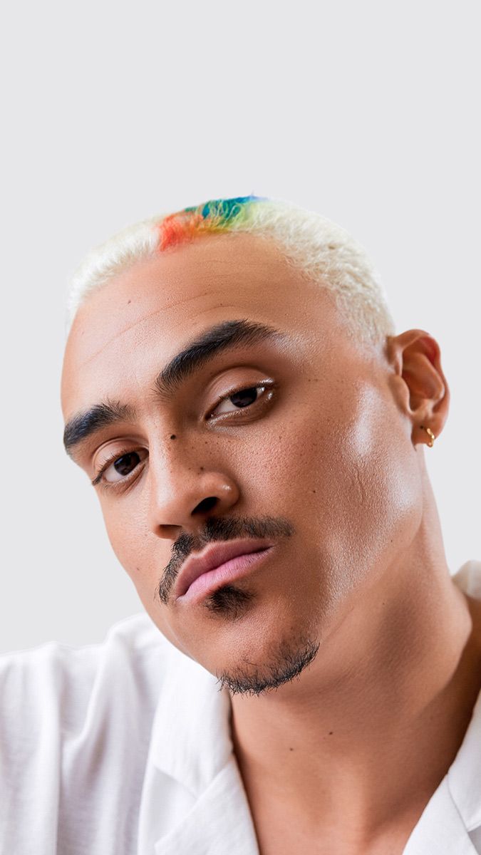 Man With A Rainbow In His Hair Is Wearing A White Shirt — Siddha Hair Studio in Currajong, QLD