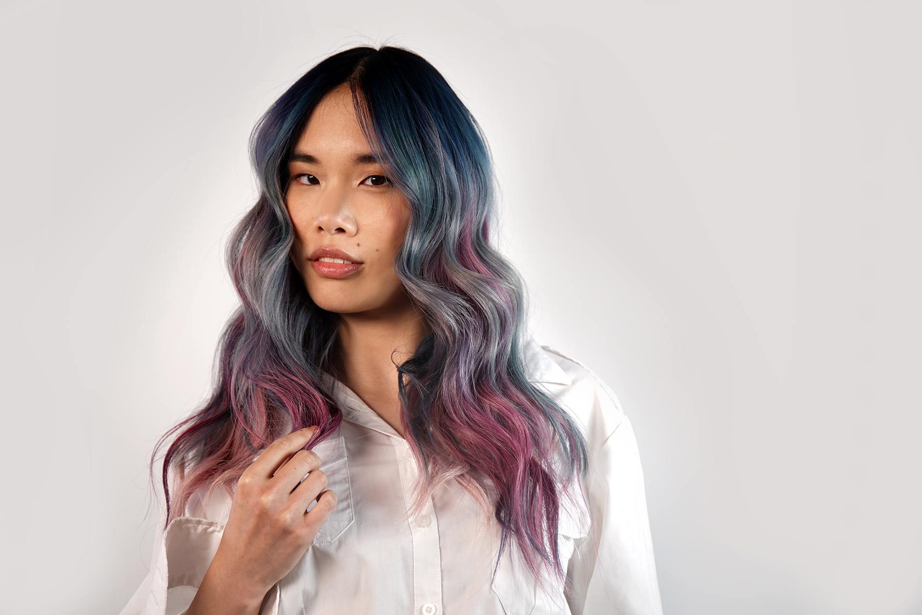 Woman With Long Purple And Blue Hair Is Wearing A White Shirt — Siddha Hair Studio in Currajong, QLD