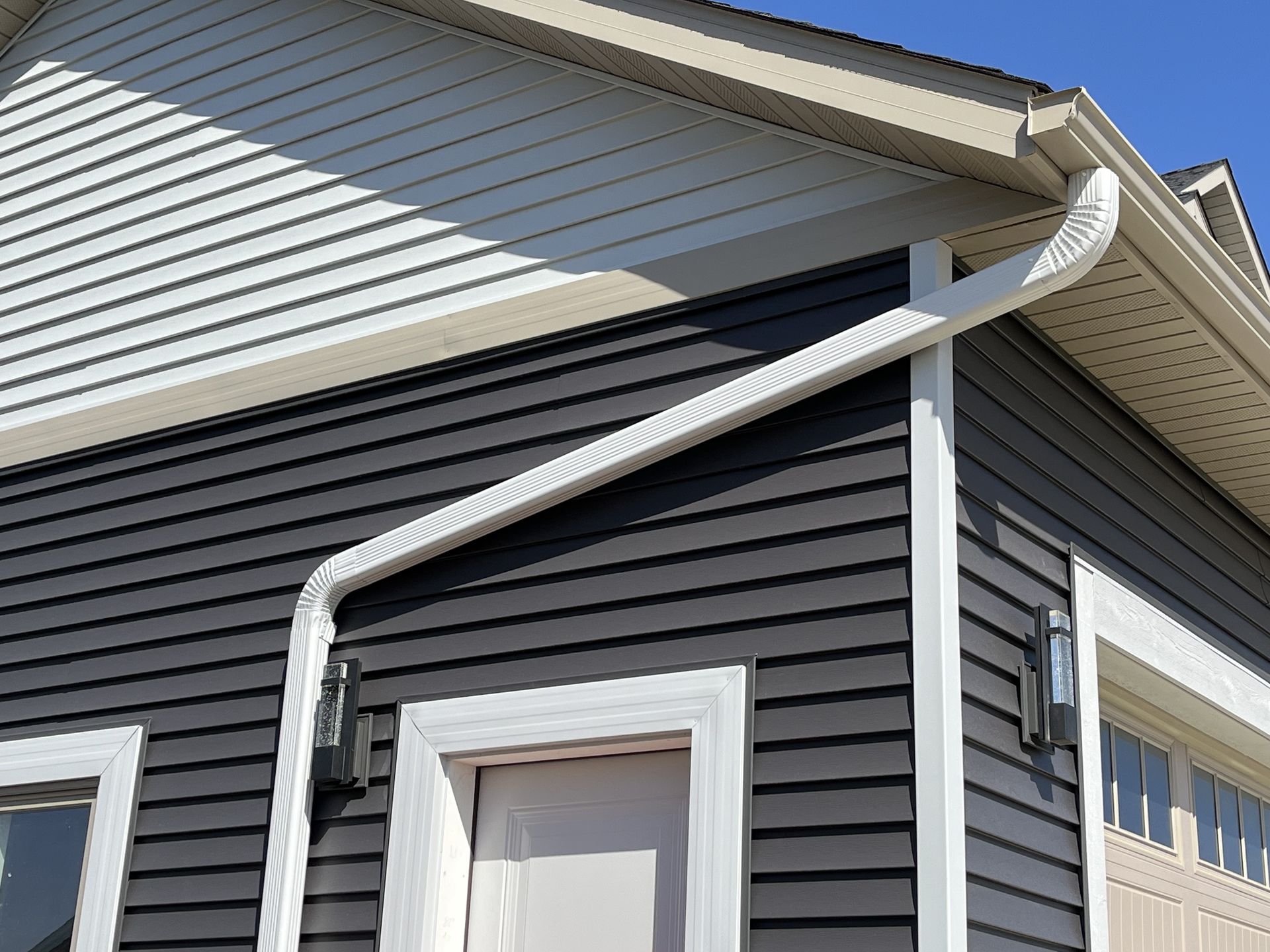 Worker Attaching Aluminum Rain Gutter To Fascia Of House - Rochester, Mn - Clark's Seamless Gutters Inc
