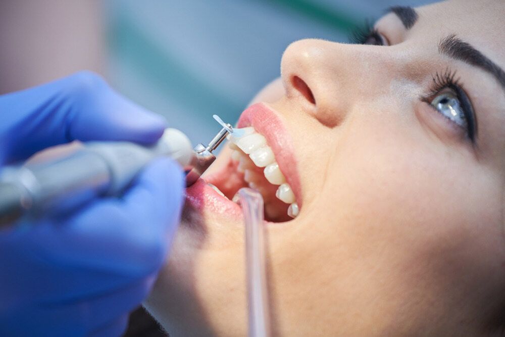 A Woman is Having Her Teeth Examined by a Dentist — Parap Family Dental in Parap, NT