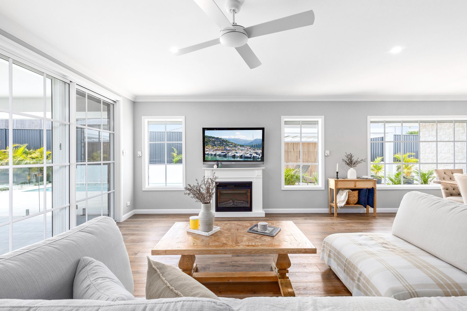 A Living Room With A Ceiling Fan And A Coffee Table — Jack West Photography In Kawungan, QLD