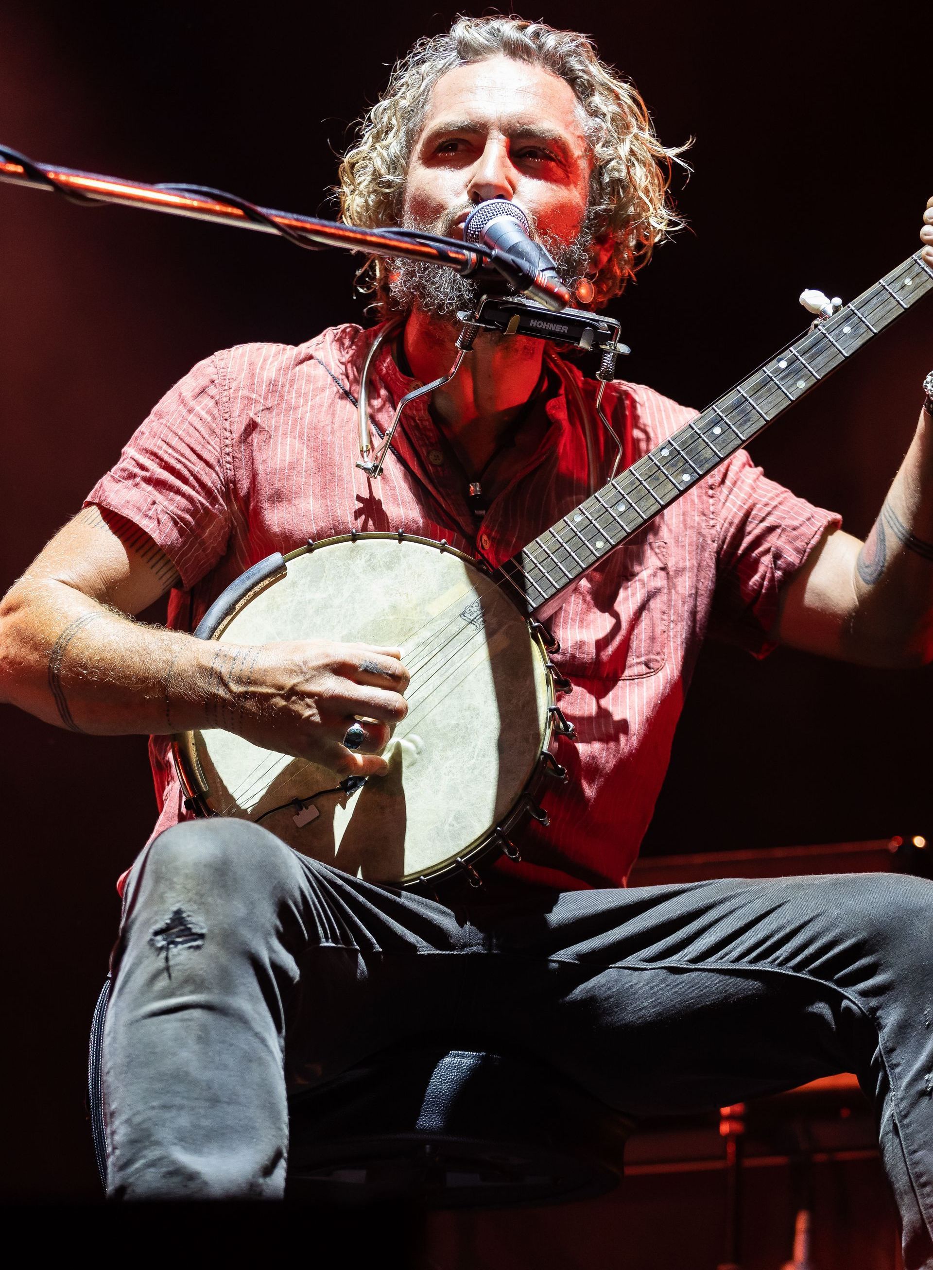 A Man Is Singing Into A Microphone While Holding An Acoustic Guitar — Jack West Photography In Kawungan, QLD