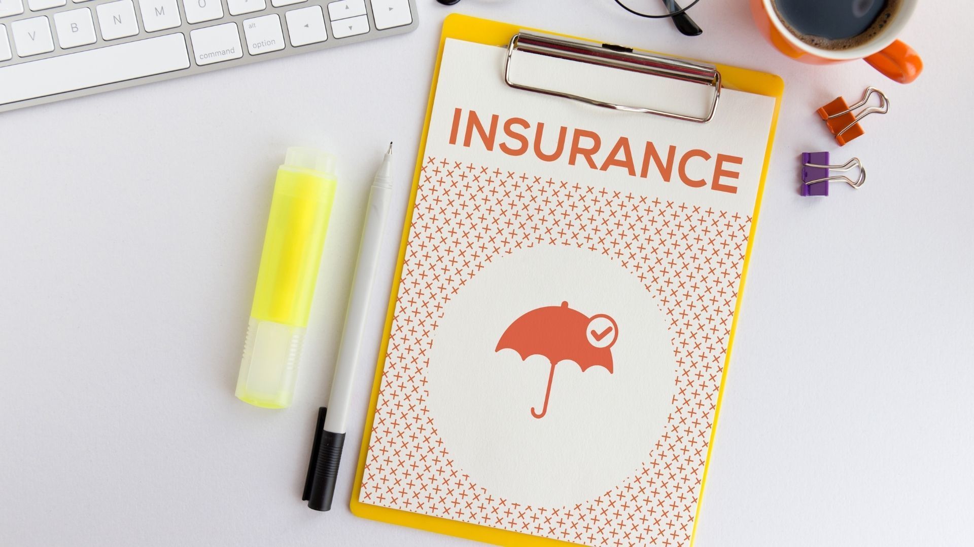 A clipboard with the word insurance written on it.