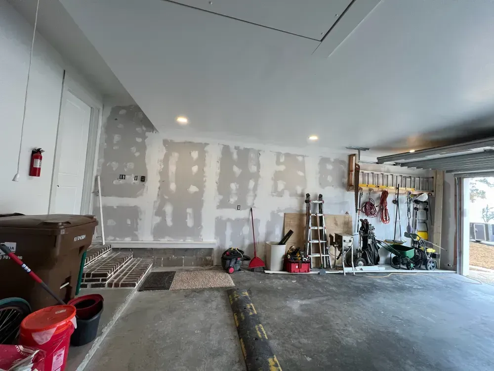 A garage with a lot of tools and a fire extinguisher on the wall.