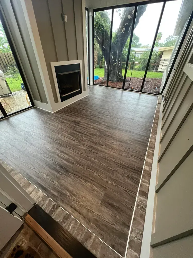 A living room with a fireplace and sliding glass doors.
