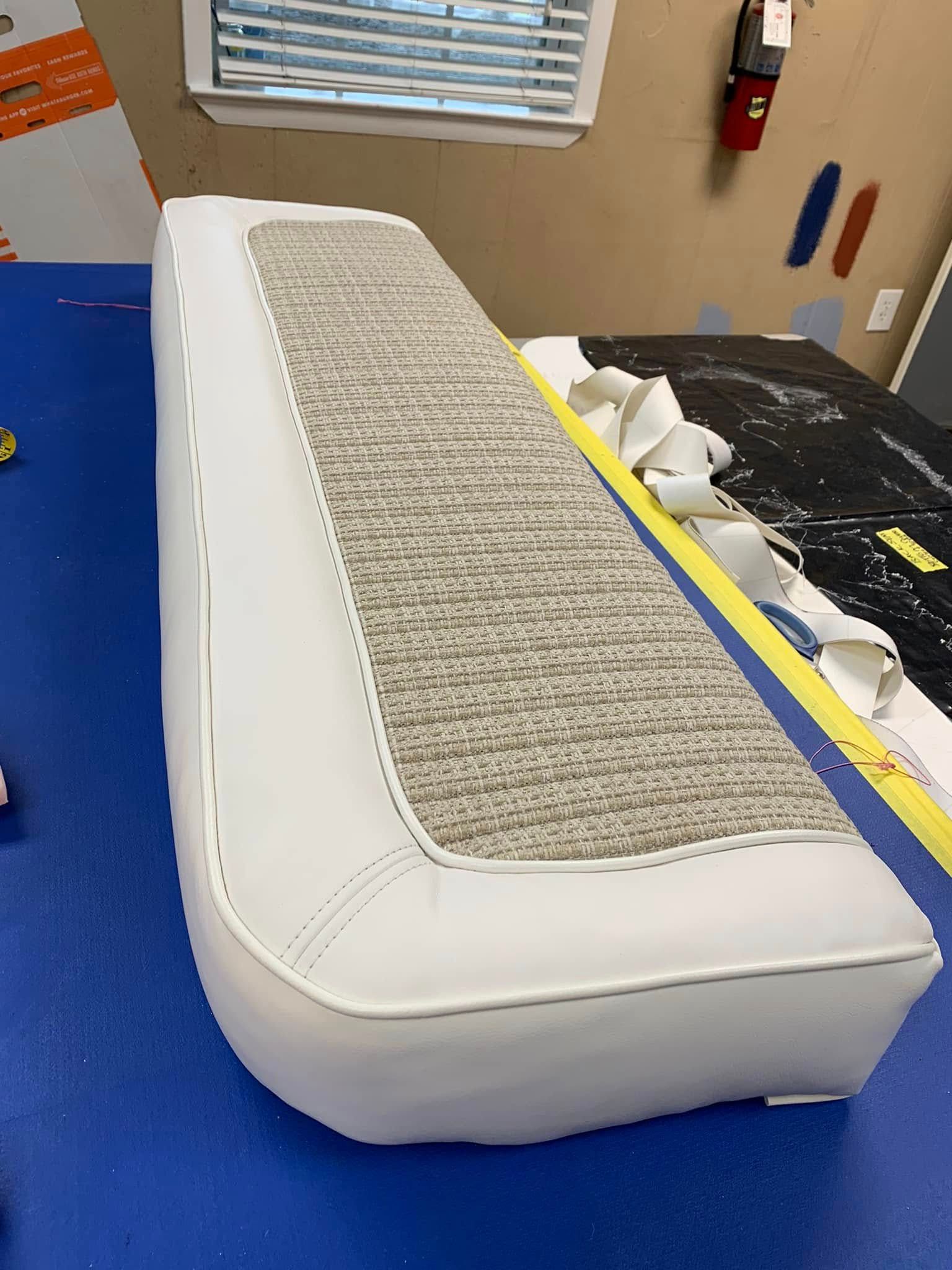 A white seat cushion is sitting on a blue table.