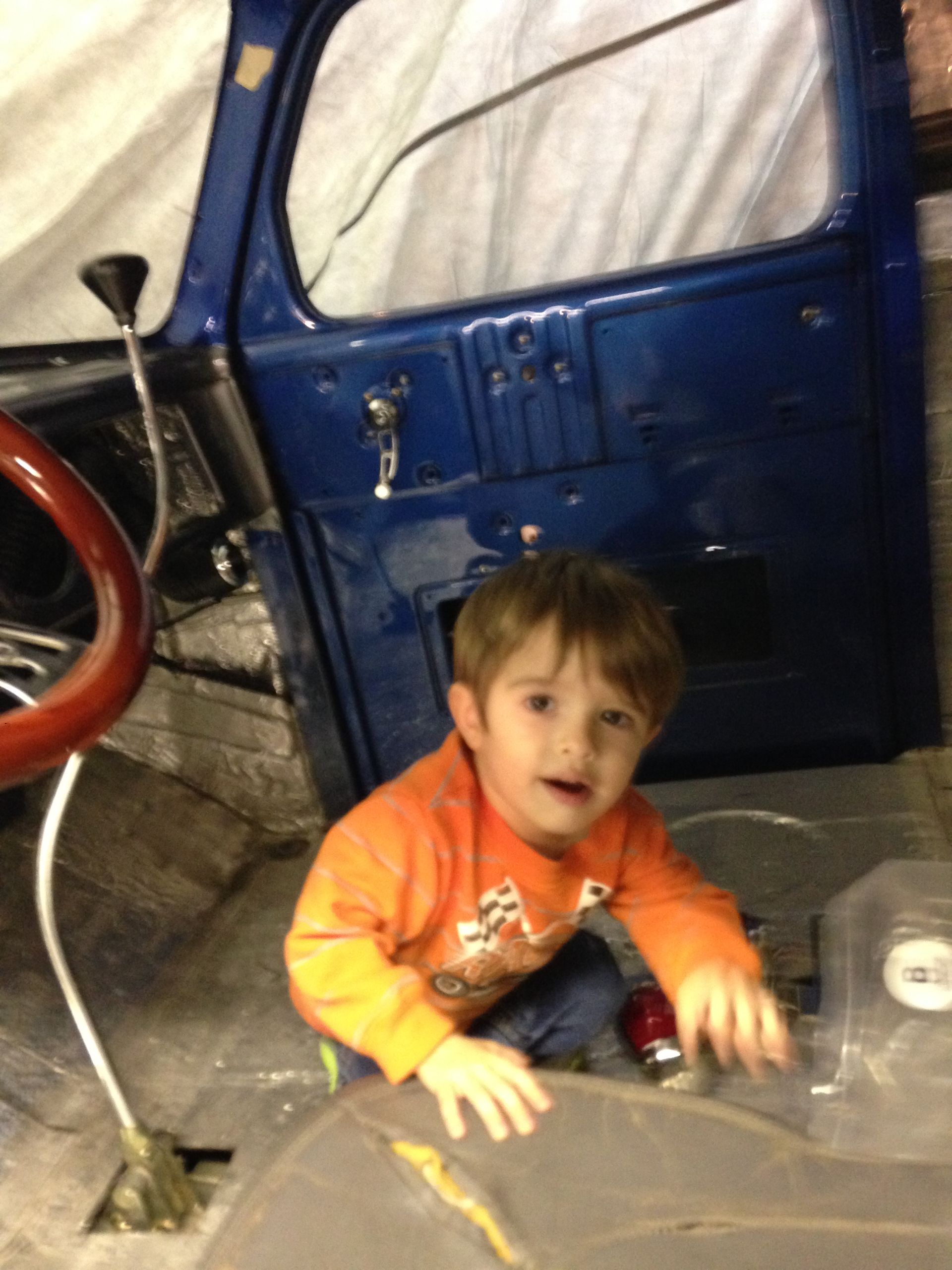 A blue and white truck is parked next to an airstream trailer.