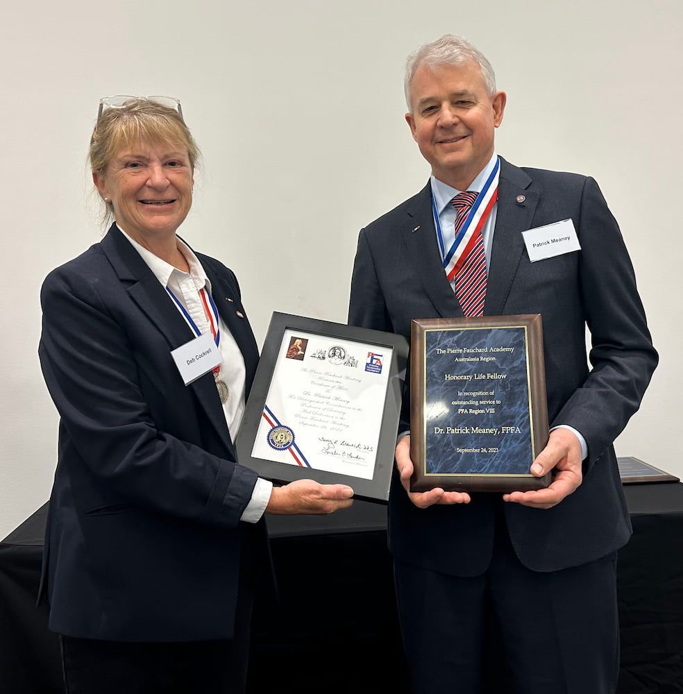 A Man And A Woman Are Holding Plaques In Their Hands — Dr Patrick Meaney In Moss Vale, NSW