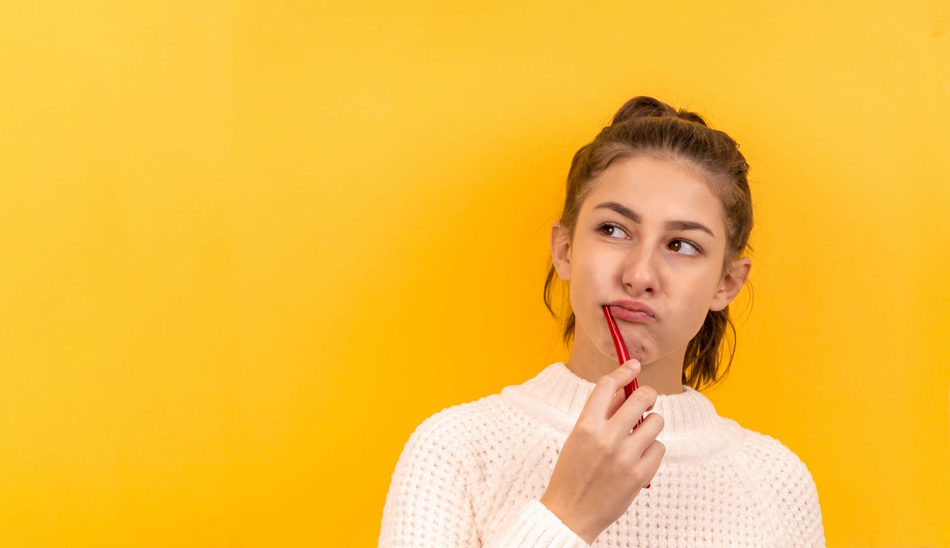 A Young Woman Is Brushing Her Teeth With A Red Toothbrush — Dr Patrick Meaney In Moss Vale, NSW