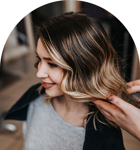 A Woman is Getting Her Hair Done by a Hairdresser in a Salon
