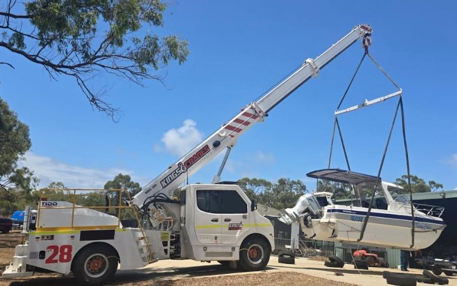 Two Cranes Lifting a Large Green Beam on a Construction Site — Kings Cranes in Airlie Beach, QLD