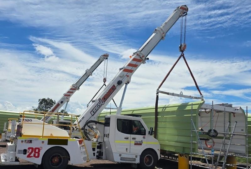 Crane Lifting a Large Concrete Beam at an Outdoor Work Site — Kings Cranes in Collinsville, QLD