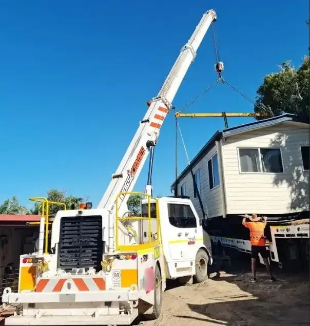 Crane Lifting a White House Module While Workers Guide It on a Sunny Day — Kings Cranes in Airlie Beach, QLD