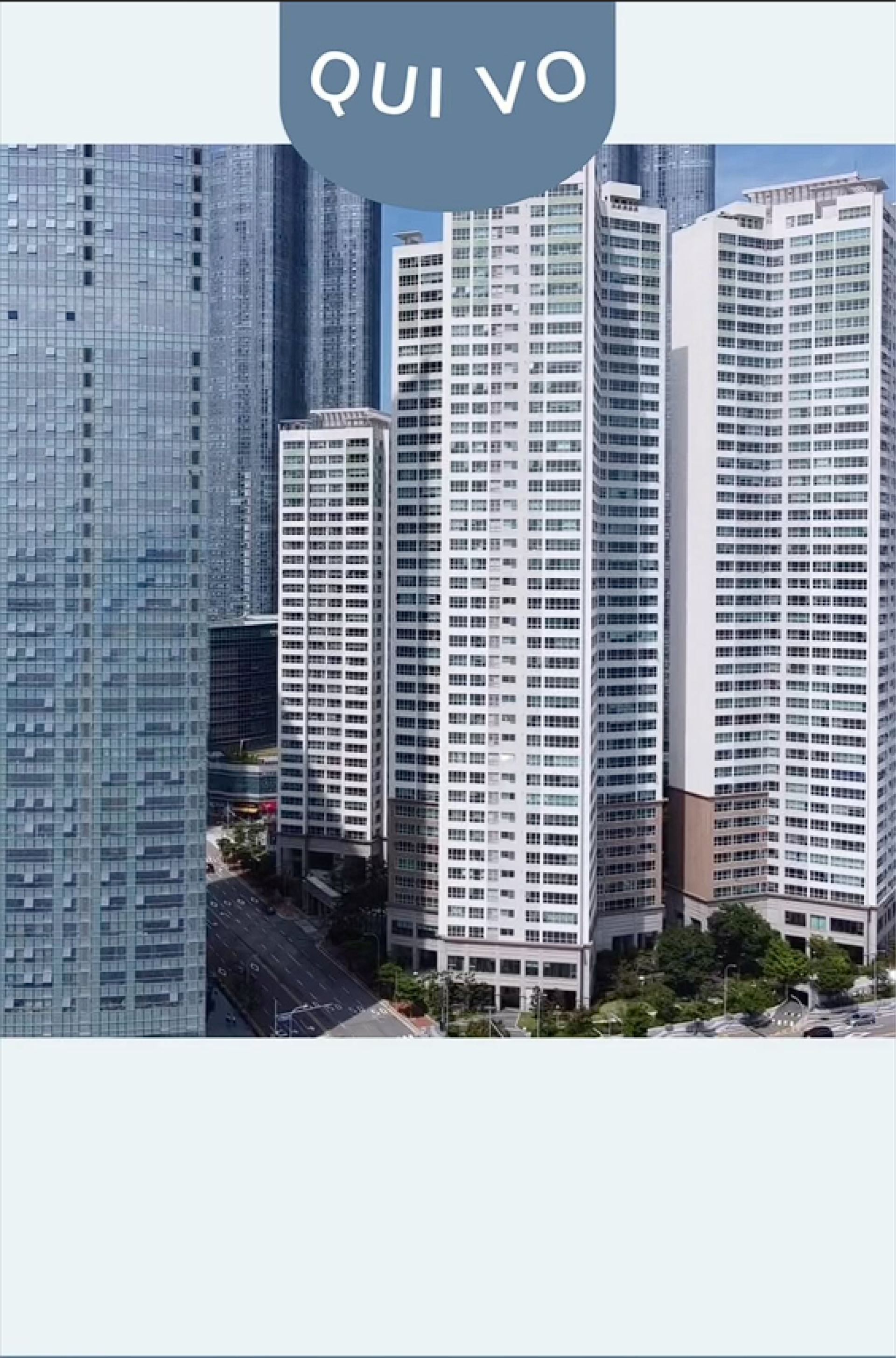 A bunch of tall buildings are lined up in a city.