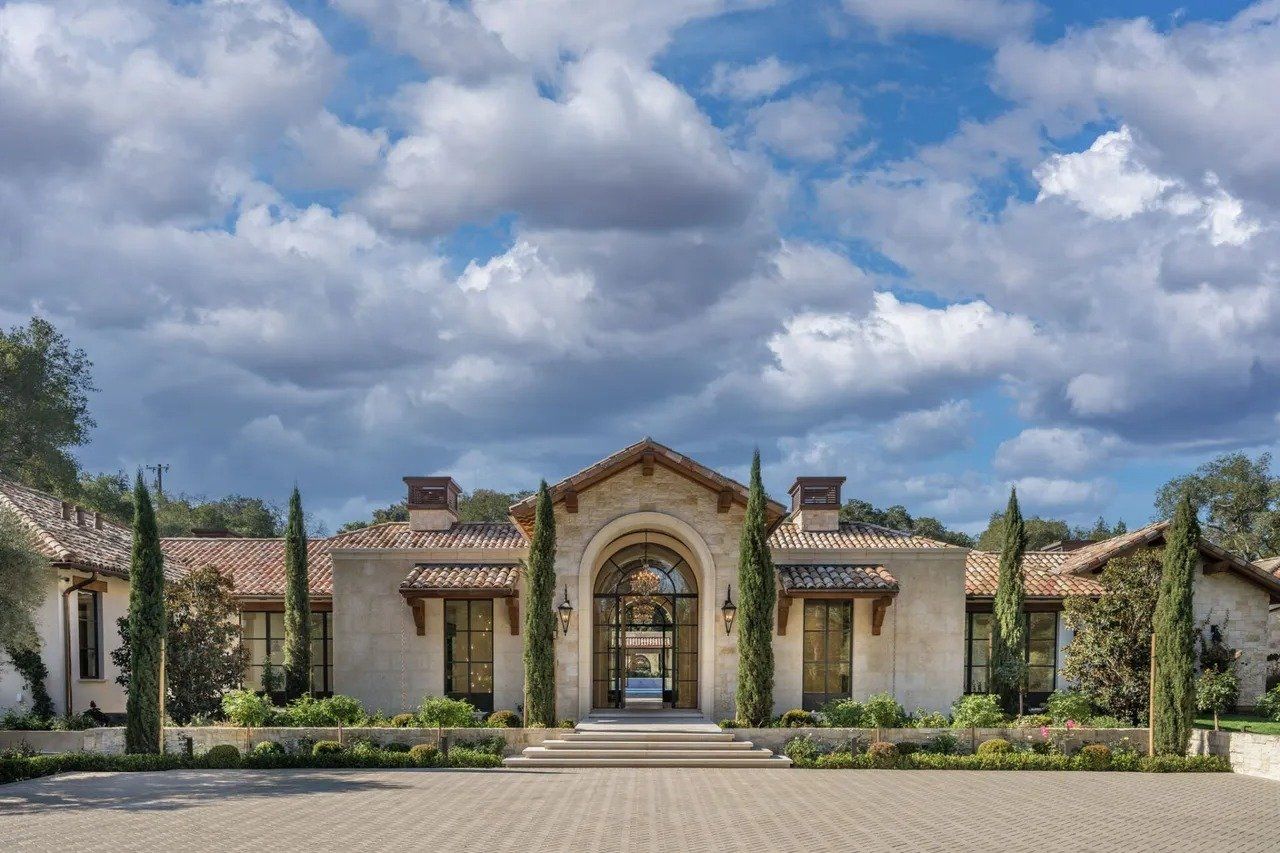 A large house with a lot of trees in front of it.
