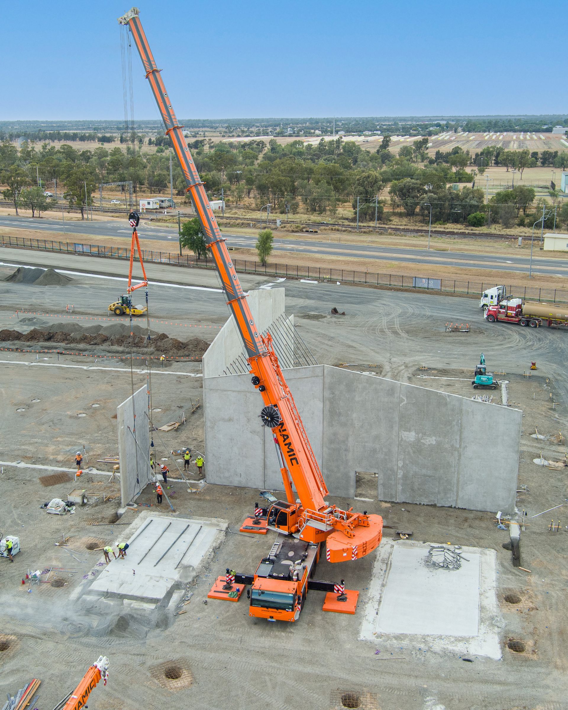 An Aerial View Of A Construction Site With A Large Orange Crane — Dynamic Crane Hire In Emerald, QLD