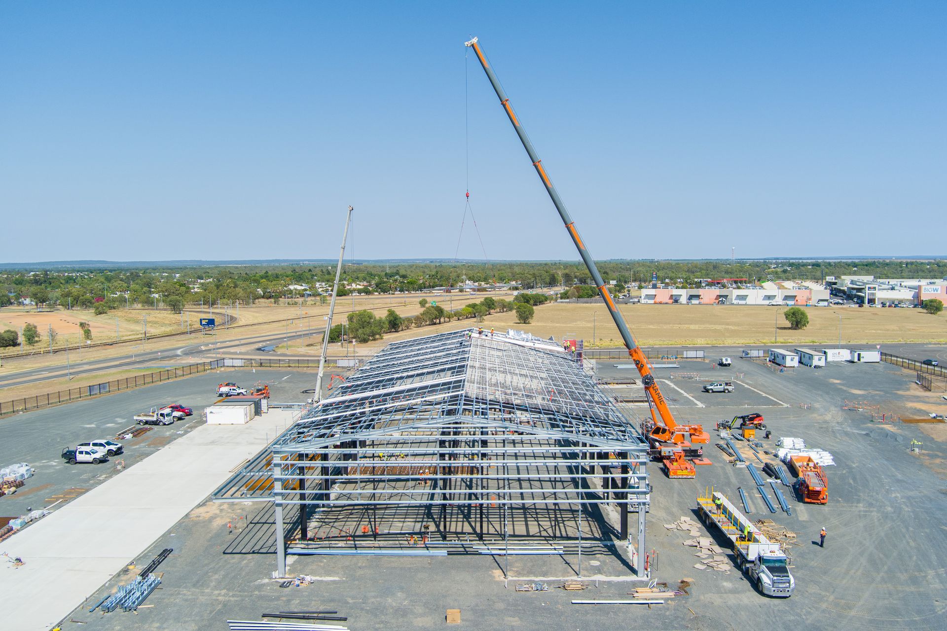 An Aerial View Of A Construction Site With A Crane Lifting A Metal Structure — Dynamic Crane Hire In Blackwater, QLD