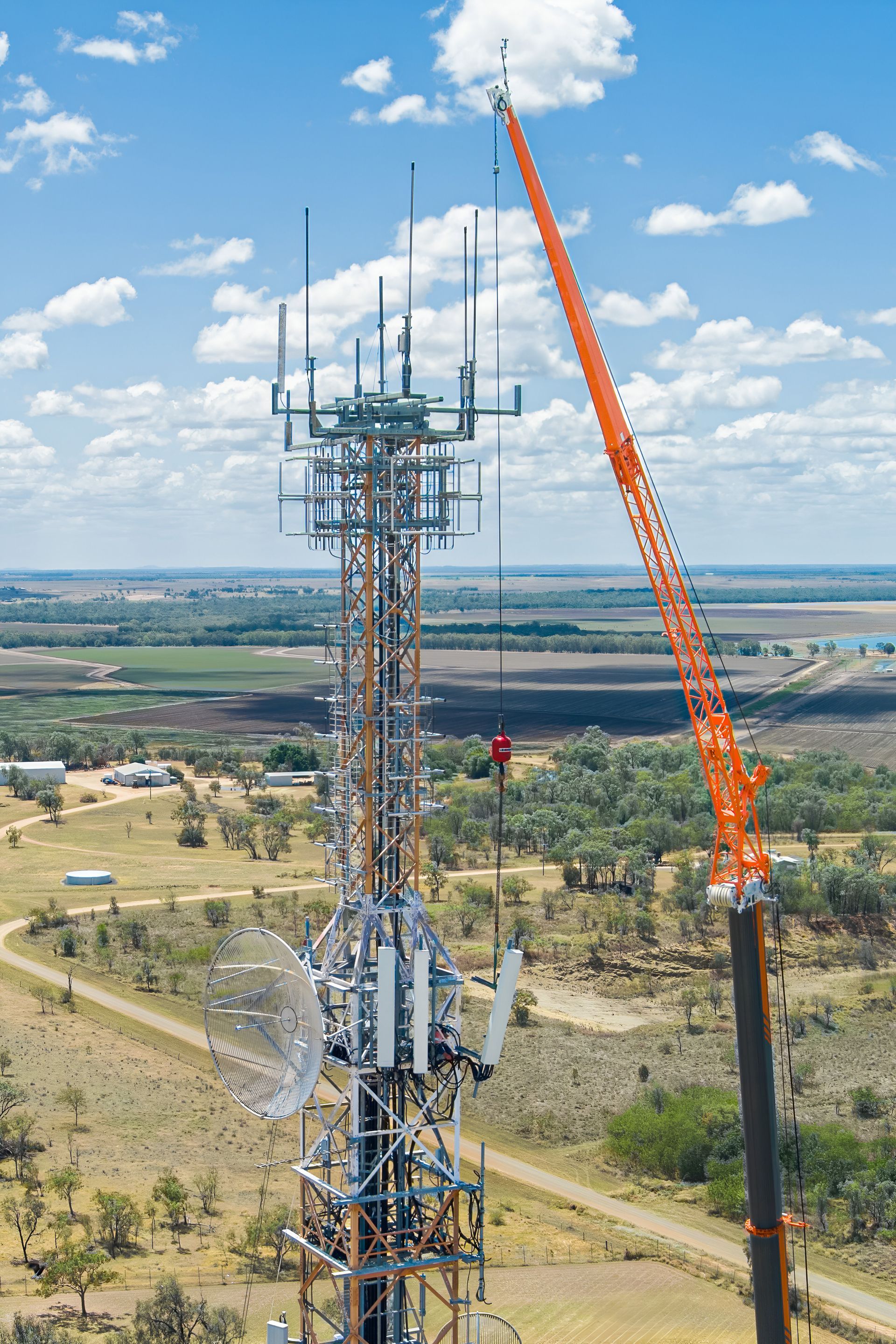 An Aerial View Of A Telephone Tower Being Built With A Crane — Dynamic Crane Hire In Emerald, QLD