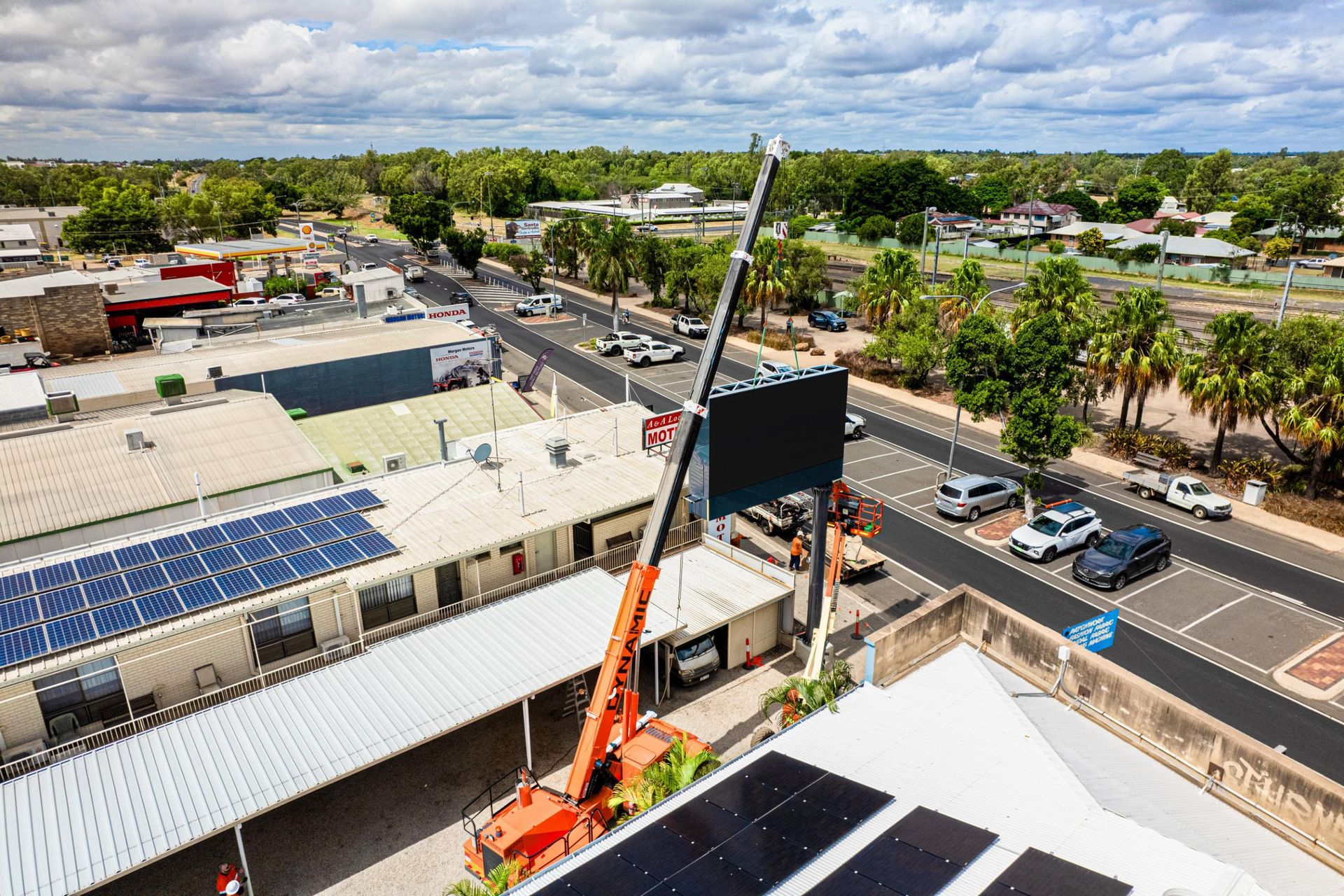 An Aerial View Of A City With A Crane And Solar Panels On The Roof — Dynamic Crane Hire In Capella, QLD