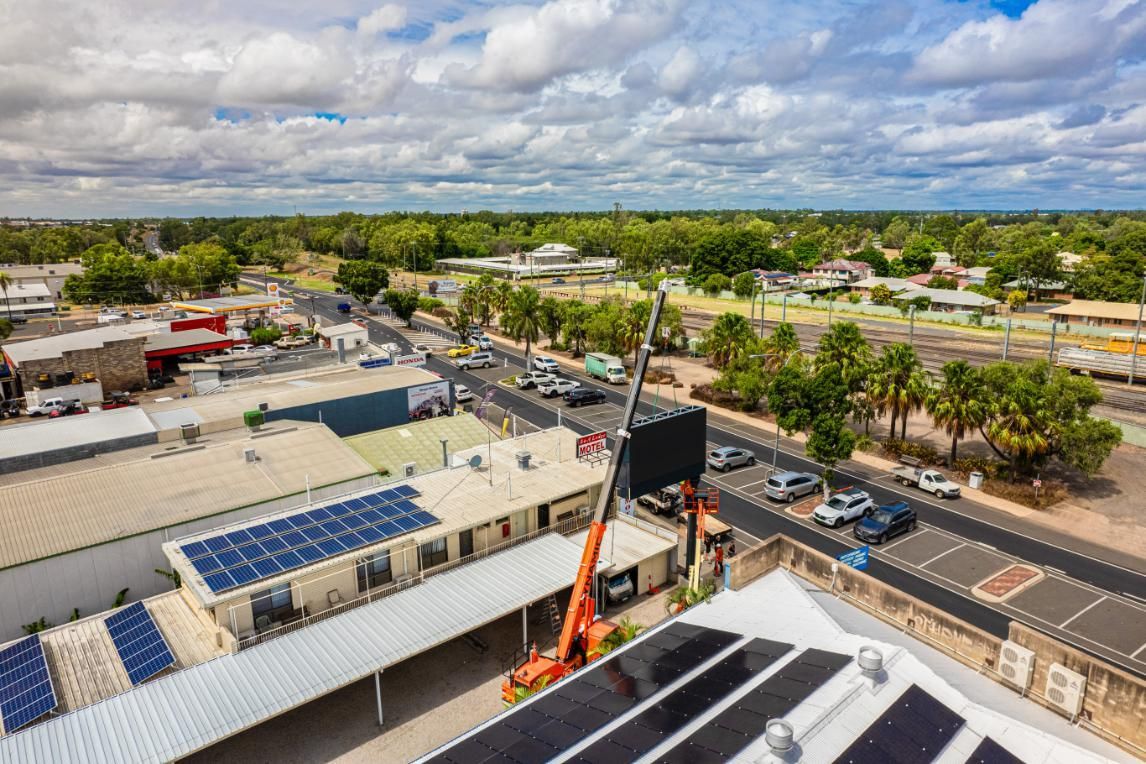 An Aerial View Of A City With Solar Panels On The Roof — Dynamic Crane Hire In Capella, QLD