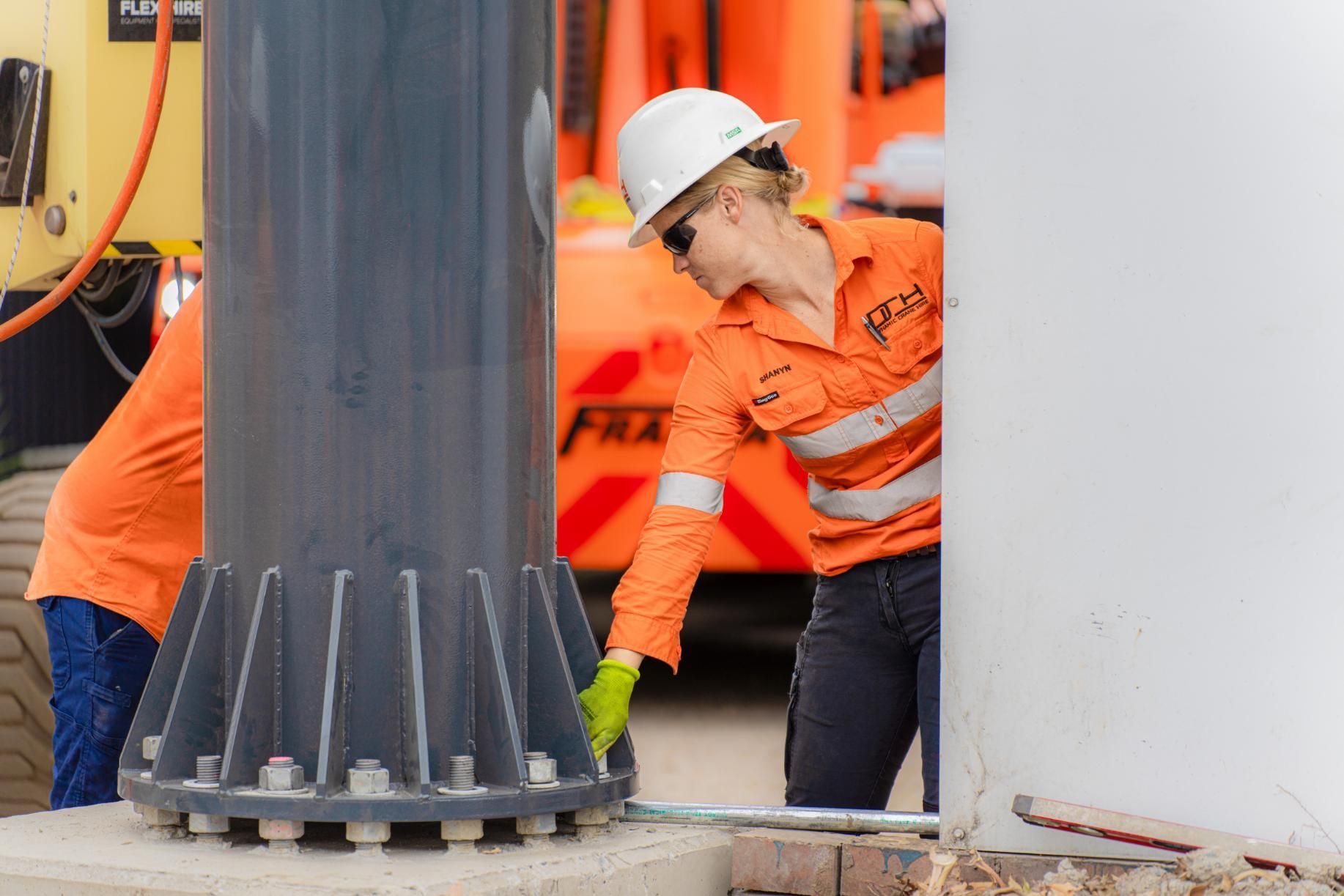 A Crane Worker  Tightening Bolts at the base of a Crane — Dynamic Crane Hire In Emerald, QLD