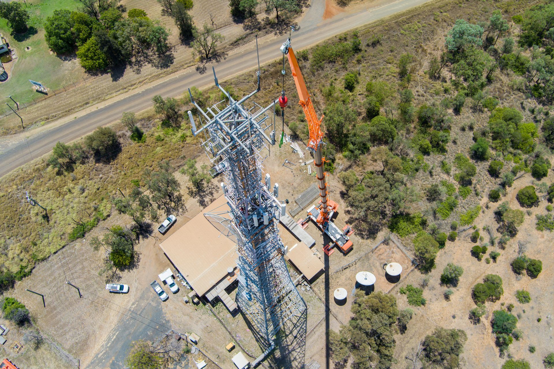 An Aerial View Of A Telephone Pole Being Built With A Crane — Dynamic Crane Hire In Emerald, QLD