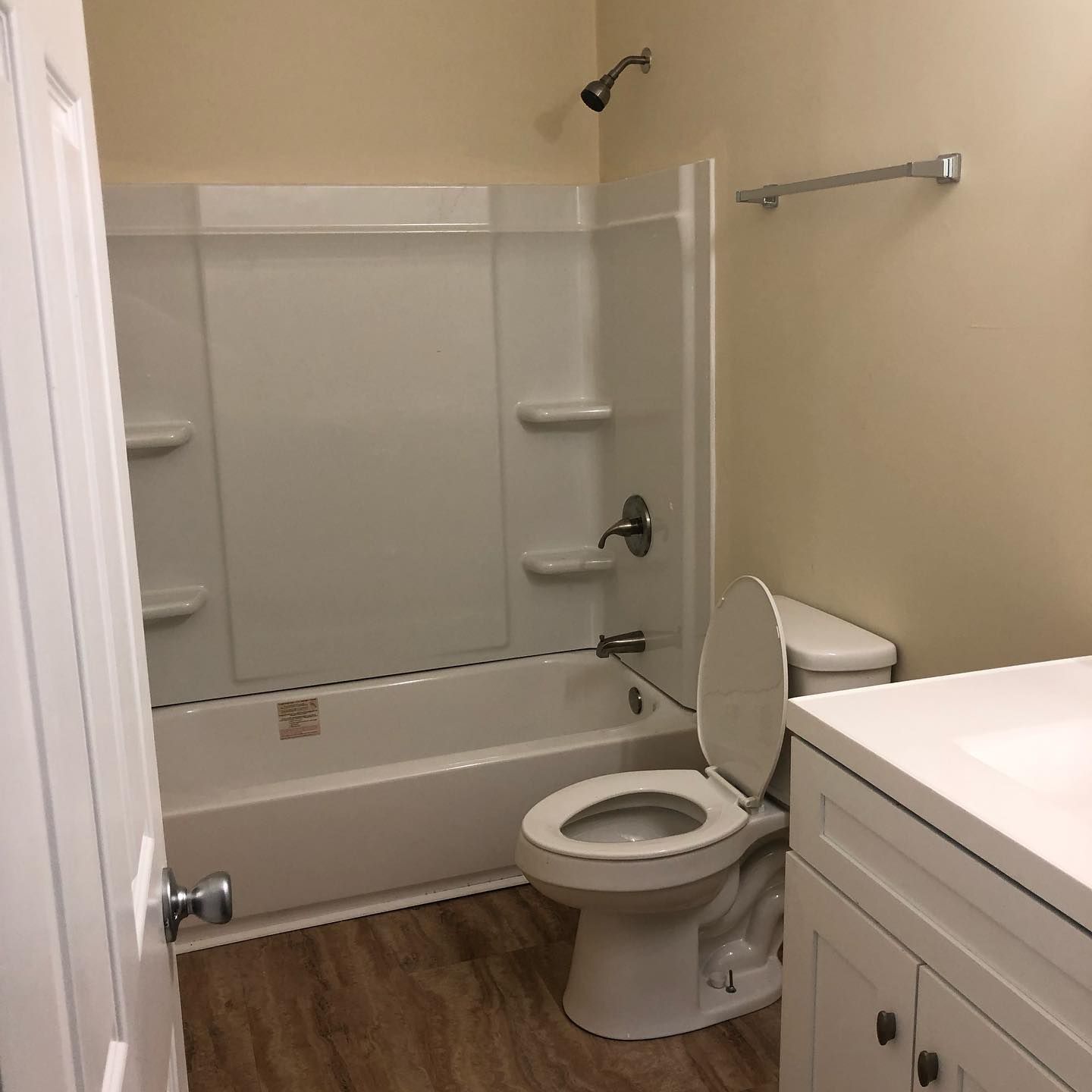 A bathroom with a toilet , sink , bathtub and shower.