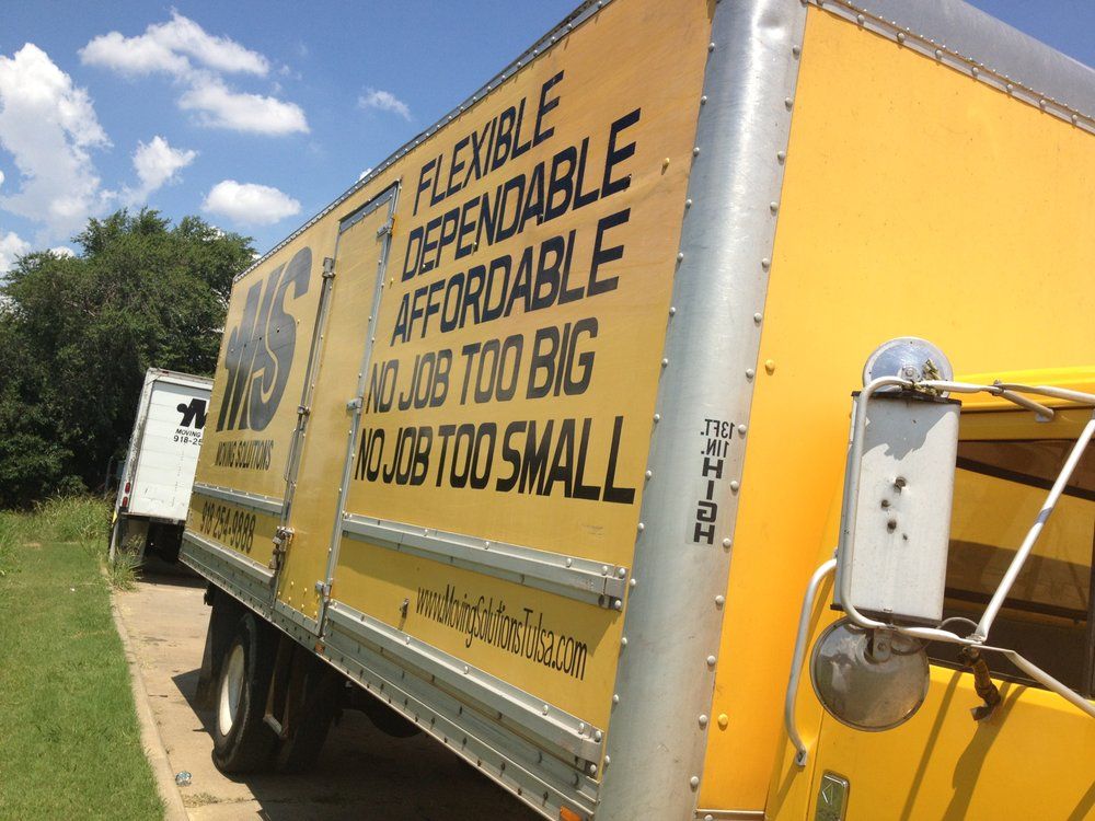 Yellow moving truck with slogan “Flexible, Dependable, Affordable—Job too big or too small” on the side