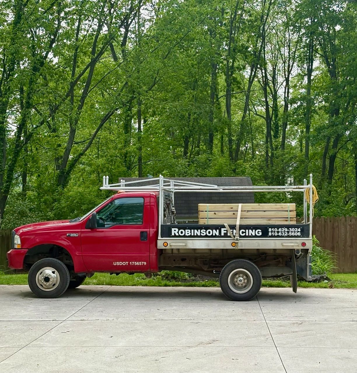 A red robinsons truck is parked in a parking lot