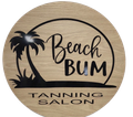 A round, wood-grain sign with a black palm tree silhouette and the text "Beach BUM TANNING SALON."