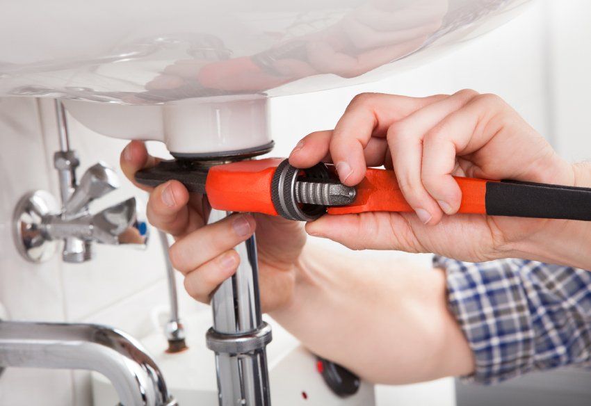 The image of a professional doing plumbing services in Elk River, MN