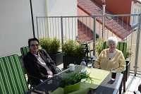Kundinnen der Tagespflege sitzen gemeinsam auf der Dachterrasse