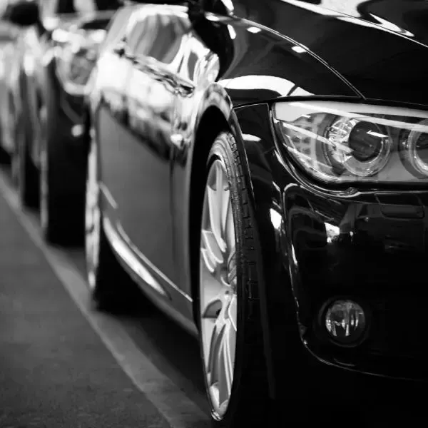 A black and white photo of a row of cars