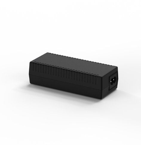 A black power supply is sitting on a white surface